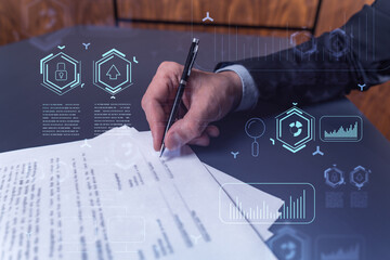 A client in dark blue suit is signing a contract to create a new software to present it in start up...