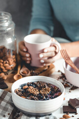Fruit plate with granola. Exotic fruits. Woman healthy breakfast