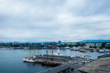 Fototapeta na wymiar Oslo, Norway, July 27, 2013: port, Oslo's port area with vintage sailboats on a cloudy day. 