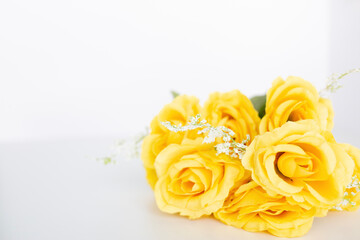 yellow roses flat lay against a white background