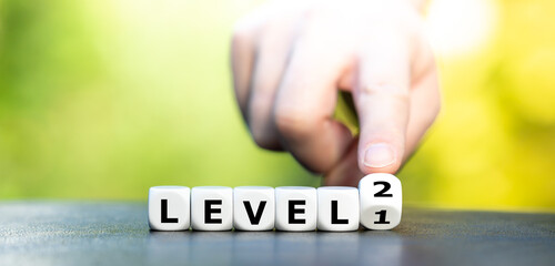 Hand turns dice and changes the expression "level 1" to "level 2".