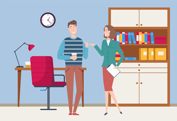 Smiling colleagues have a friendly conversation. Business meeting or working process. Woman standing in office workspace holding a document talking to man. Project management and teamwork concept