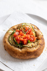 Focaccia with tomato and zucchini on white background
