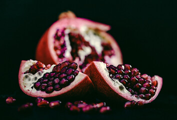pomegranate pieces on black background