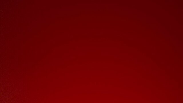 Tomato ketchup is squeezed from a red bottle with white lid. Stock footage. Close up of a drop of tomato sauce falling down from the bottle isolated on red background.