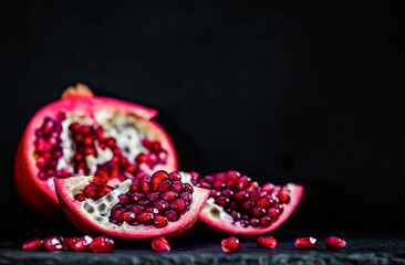 pomegranate pieces on black background