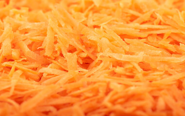 Soft focus. Full frame of grated carrots. The texture of grated carrots. Food background.