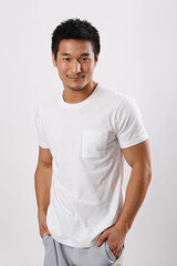 A young man in casual wear holding a trophy 