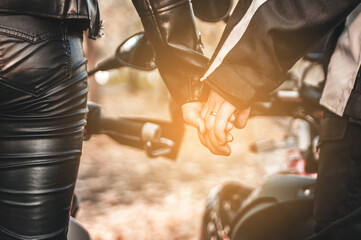 Fototapeta na wymiar Hands of couple bikers. Happy Valentine's Day.