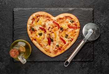 heart shaped pizza for valentine's day on stone background