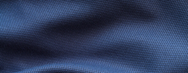 High resolution with details, banner shot of formal dark blue wool suit fabric texture. with button decoration under light and shadow ambient. Ideal for background or wallpaper.