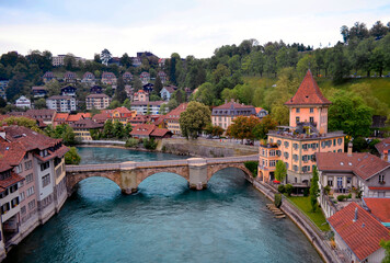 Fototapeta na wymiar View along Aare River toward Untertorbrucke Bridge and Felsenburg Castle in Bern Switzerland