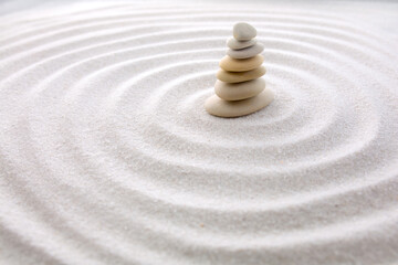 Fototapeta na wymiar Seven balancing stones. Japanese zen garden meditation for concentration and relaxation sand for harmony and balance in pure simplicity - macro lens shot.