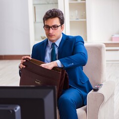 Businesman watching tv in office