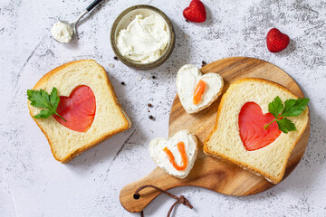 Breakfast for valentine's day or mother's day, toast with salmon and curd cheese with the inscription that I love you. Top view flat lay.