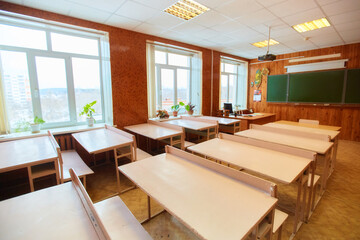 Interior of an empty school classroom. Concept of coronavirus COVID-19 quarantine in schools and educational institutions.