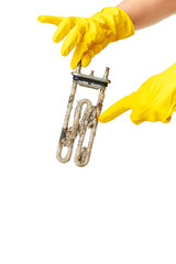 A hand holds the heating element of a washing machine or dishwasher, covered with a lime coating. The concept of replacement, repair or disposal.