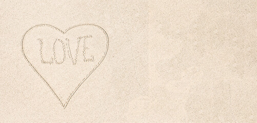 Drawn Heart with word LOVE on white sand, close up, top view. White sand background, copy space