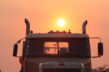 Large truck with the sun behind it, at sunset in Bolivia.