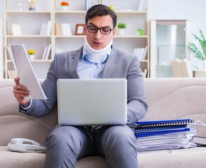 Man in neck brace cervical collar working from home teleworking
