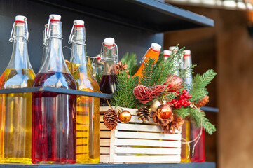 Street decoration with bottles and Christmas tree branches.