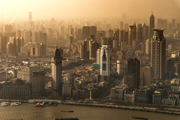 Smog lies over the skyline of urban architecture city and modern skyscraper on the bund of Shanghai city in misty sunrise, Shanghai, China