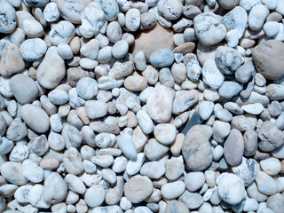 pebbles on the beach, white stone background