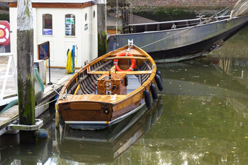 Fototapeta na wymiar Brown Boat in the old historic Harbor of Zierikzee