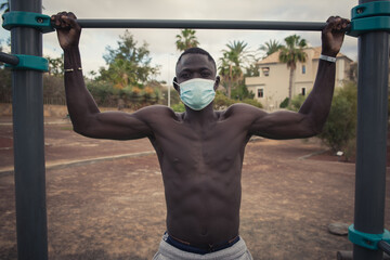 Fototapeta na wymiar young black man exercises with face mask outdoors