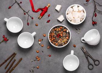 Top view of workplace with rose hips, organic peanuts, birdseeds, coconut fat and tools to create...