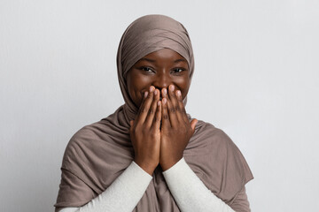 Laughter. Positive Black Muslim Woman In Hijab Covering Mouth With Hands