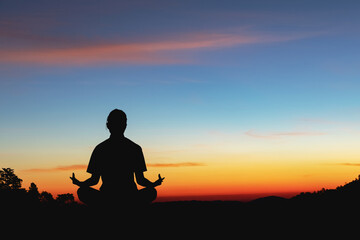 Silhouette of woman meditating at sunset.sport for weight loss concepts