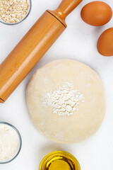 Dough with flour, olive oil, eggs and rolling pin. cooking and baking ingredients
