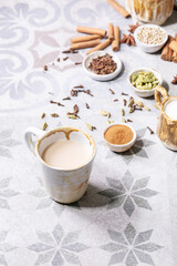 Obraz na płótnie Canvas Masala chai served with cinnamon sticks