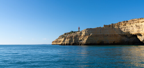 Fototapeta na wymiar view of the Alfanzina lighthouse on the beautiful Algarve coast of Portugal