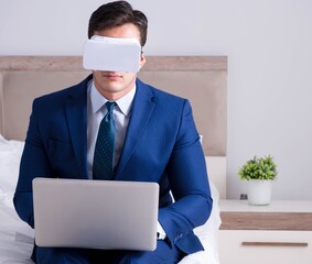 Businessman wearing a virtual reality headset in the bedroom