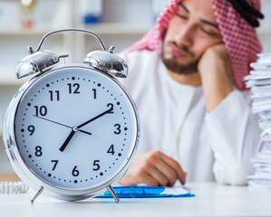 Arab businessman working in the office doing paperwork with a pi