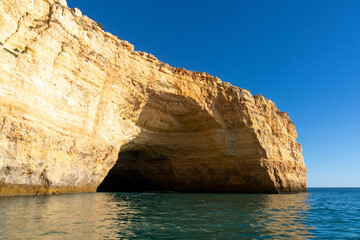 Fototapeta na wymiar rock and cliff coast under a brigh blue sky with sea caves on the Atlantic coast