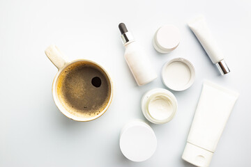 Flat lay composition with skin care products and coffee cup on white background