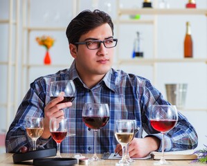 Professional sommelier tasting red wine
