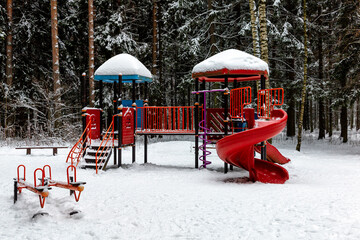 Children's playground in the winter forest. Activity and development.