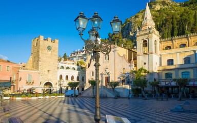Square Piazza IX Aprile with San Giuseppe church and Clock Tower in Taormina, Sicily, Italy.