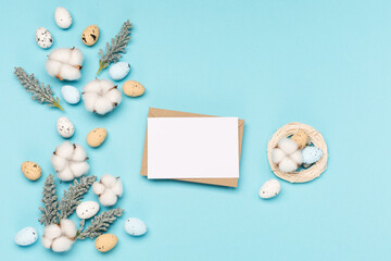 Craft Easter eggs on blue pastel background, space for text. Flat lay image composition, top view.