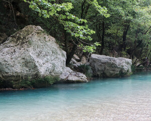 The mystical Acheron River. Blue river water surrounded by trees and rocks. exotic places to visit in greece