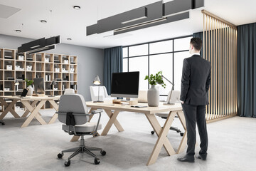 Businessman standing in modern hipster style office