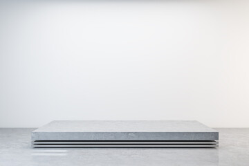 Rectangular concrete pedestal in gallery interior.