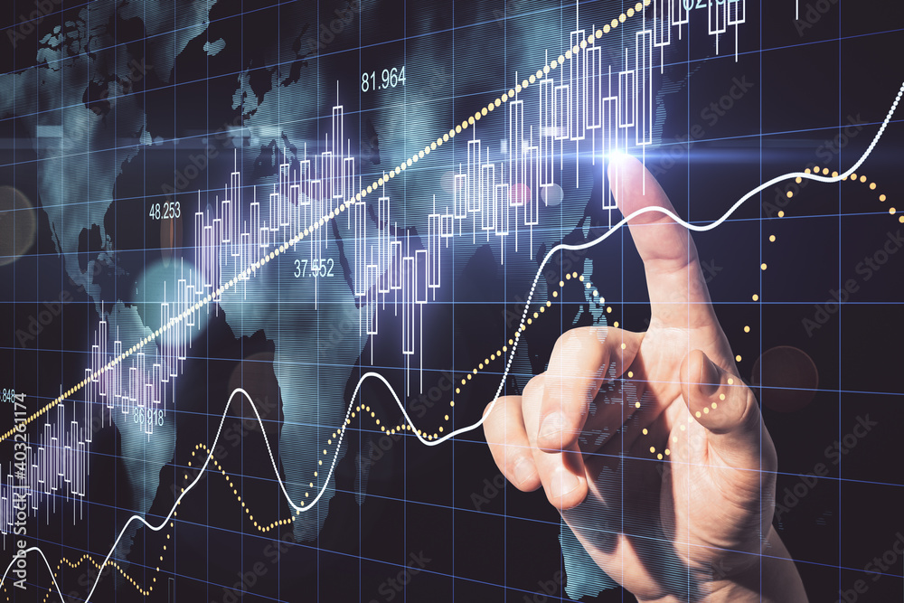 Aufkleber Hand using candlestick chart with digital world map hologram