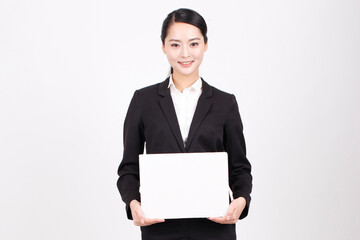 A business woman holding a white board
