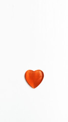 Orange heart for valentine's day. Cabochon heart isolated on white background. Stone cabochon from cat's eye heart.