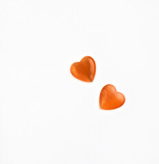 Orange hearts for valentine's day. Cabochon heart isolated on white background. Stone cabochon from cat's eye heart.